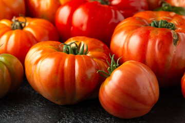 Ripe Beefsteak Tomatoes on rustic black table