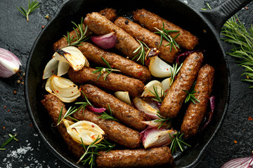 Rosemary and onion vegetarian vegan sausages oven baked in cast iron skillet frying pan