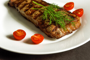 steak ribeye on the white plate looks very tasty