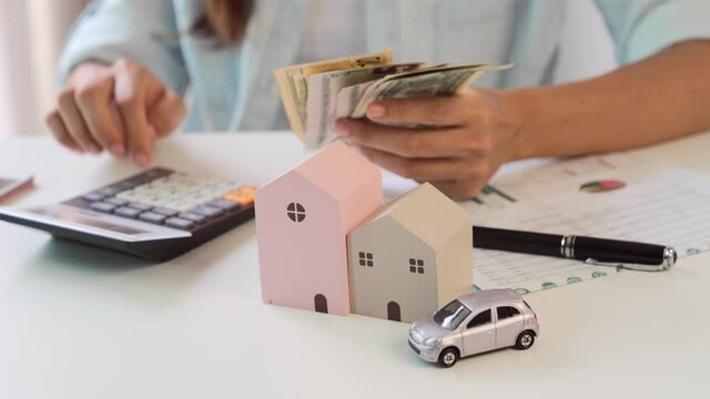 Stressed young woman calculating monthly home expenses and Car installment, Income is not enough for expenses
