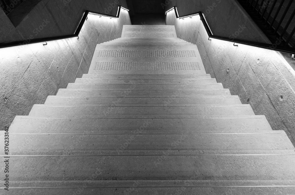 Poster illuminated empty old stairway in the dark