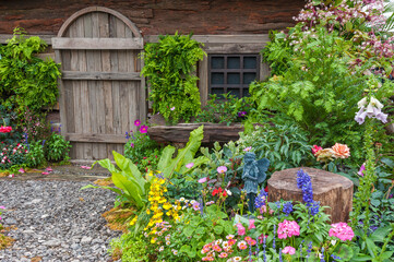 Fototapeta na wymiar Landscaped backyard of a old house with flower garden