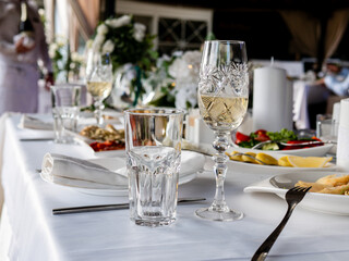 Set table in the restaurant. Empty glasses on the table in the restaurant waiting for guests.