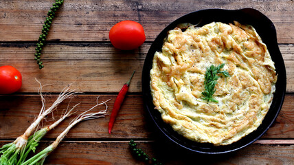 Omelet on a black tray