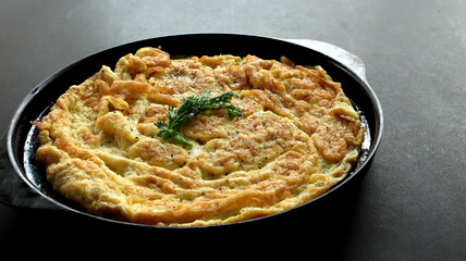 Omelet on a black tray