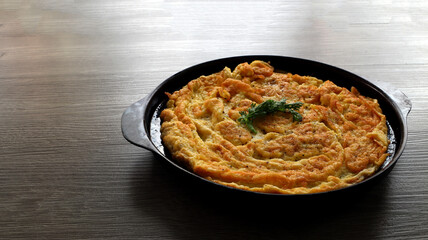 Omelet on a black tray