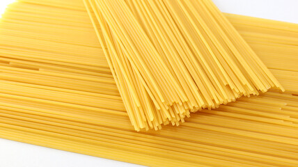 Yellow long spaghetti on white background