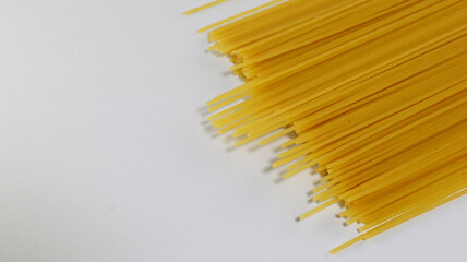 Yellow long spaghetti on white background