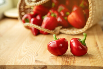 Red peppers in the basket. Raw Red Organic Peppers. Ripe bell peppers closeup. Picture with space for text or logos.