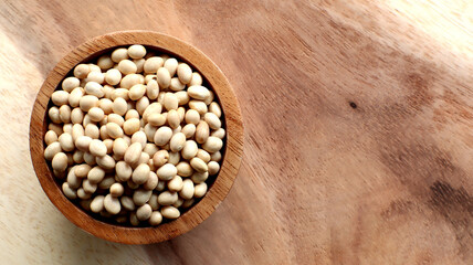 White bean seeds in a wooden bowl