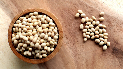 White bean seeds in a wooden bowl