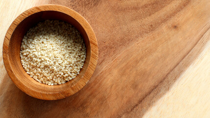 White sesame seeds in a wooden bowl