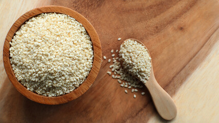 White sesame seeds in a wooden bowl