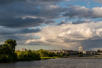 Fototapeta premium Beautiful clouds over the river and city