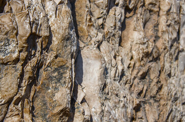 Ancient wall folded of natural rough stones, perspective view.