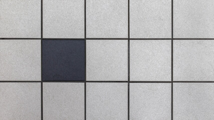 One black tile among many grays. Individuality Concept illustration.