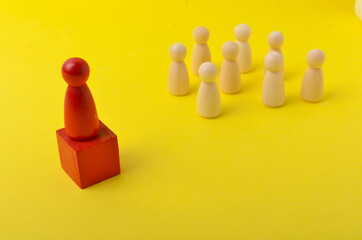 Business & HR global wood puzzle concept for leadership and team with peg doll. Selective focus.