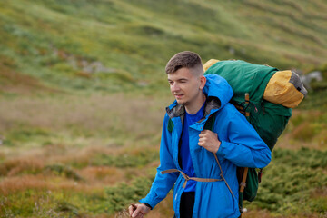 Naklejka premium Hiker on the top in Carpathians mountains. Travel sport lifestyle concept