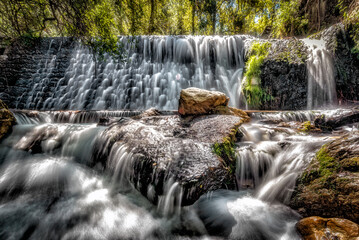 Obraz premium Refreshing waterfall in the middle of the green forest