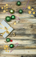 Sortiment für Weihnachten, Kugeln, Geschenk, Stern, Schnee in gold, grün und gelb auf rustikalem Hintergrund