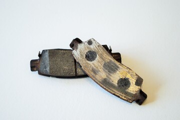 Worn out ruined disc brake pad compared to one that is new