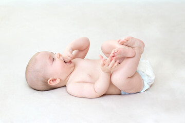 Cute baby girl lying on bed