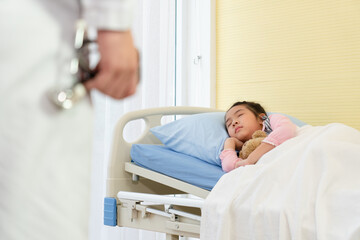 asian doctor visit young girl and mother who is sick and admitted at pediatric ward in hospital. healthcare and medical concept