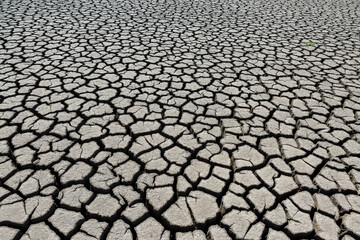 Part of a huge area of dried land suffering from drought in cracks.