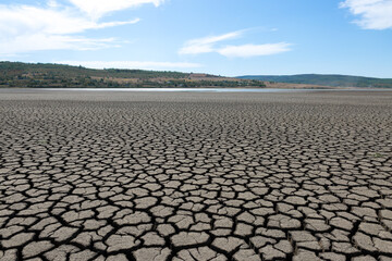 Fototapeta premium Part of a huge area of dried land suffering from drought in cracks.