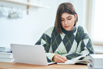 Teenage girl having online classes at home