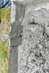 Mixing cement in the muld with shovels for construction