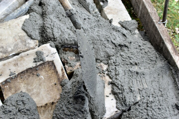 Mixing cement in the muld with shovels for construction