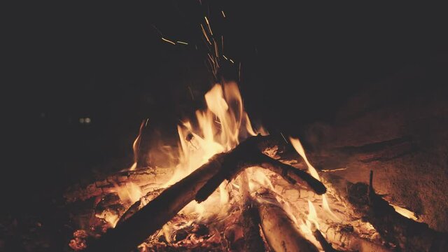 A fire in a fireplace during the night.