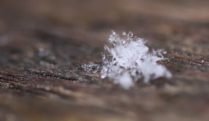 Snowflakes during the snowfall on glass surface