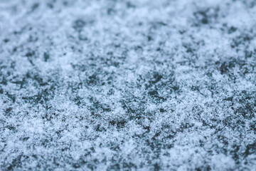 Snowflakes during the snowfall on glass surface