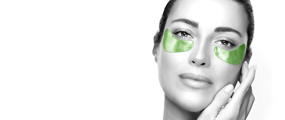 Beauty face woman with healthy clean skin using cucumber hydrogel patches. Cosmetology and skin care concept