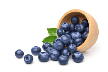 Wooden bowl pouring out fresh Blueberries isolated on white background.