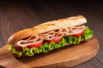 A turkey sandwich with tomato and lettuce