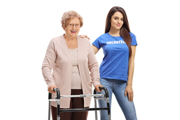 Senior woman with a walker standing with a young woman volunteer
