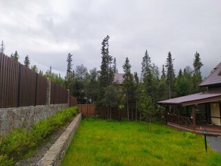 Modern brown fence near the beautiful finnish house
