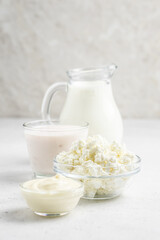 Various dairy products in glass bowls, jars. Copy space.