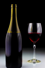 wine bottle and glass on black background