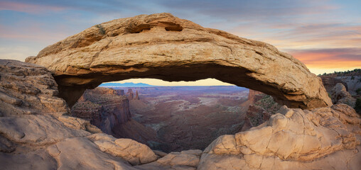 Mesa Arch and canyon panorama during a sunset