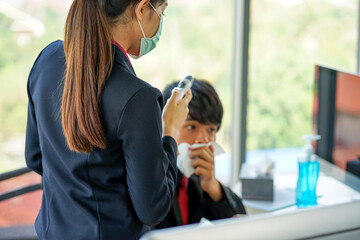 business woman worked in the office wearing surgical face mask to prevent from virus pandemic with her colleague employee