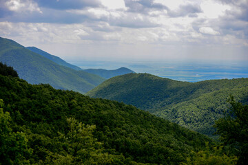Layered rolling mountain hills of green lush vegetation
