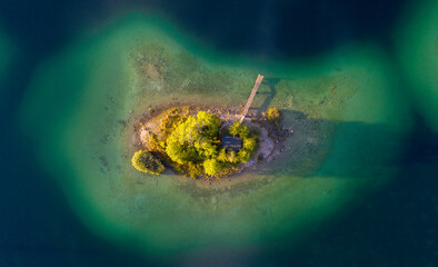 Aerial top down view of Lake Eibsee island with small hut and pier