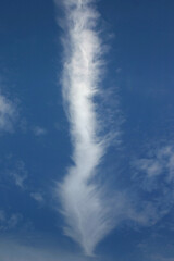 or a cloud or a plane track in the blue sky