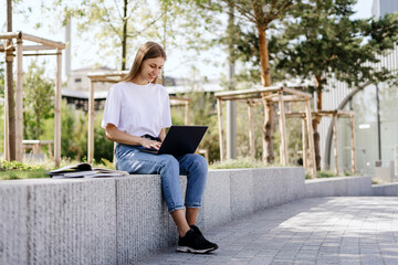 Young student girl using modern laptop computer