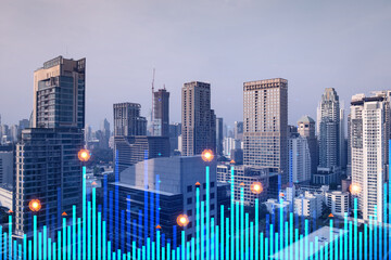 Market behavior graph hologram, sunset panoramic city view of Bangkok, popular location to achieve financial degree in Asia. The concept of financial data analysis. Double exposure.