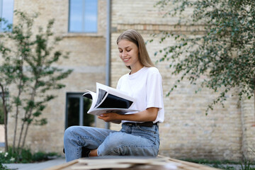 Young university student girl preparing homework for classes